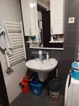Smaller bathroom with a sink, mirror, and cabinet. - image 18