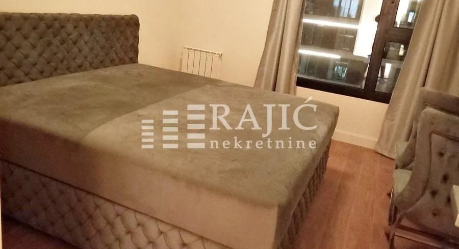 Furnished bedroom with a double bed.