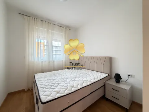 Bright and tidy bedroom with a double bed and a nightstand. - image 11