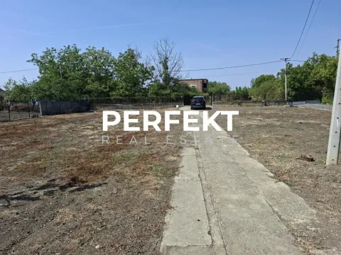 Pogled na ograđeni plac sa zemljanom površinom i stazom. - image 2