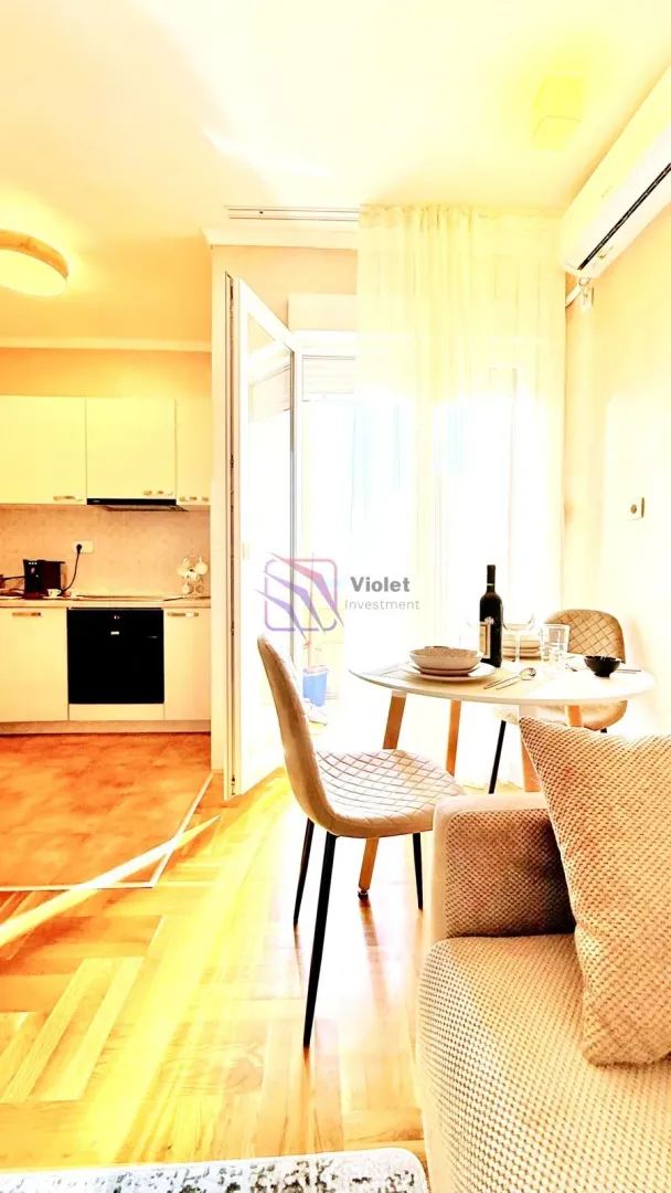 Living room with dining area and view of the kitchen.