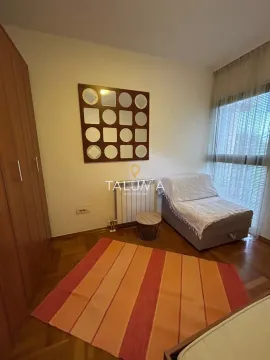 Small bedroom with a bed, wardrobe, and window with curtains. - image 4