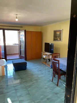 Living room with a dining table and access to the terrace. - image 3