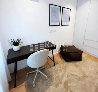Study room with a desk, chair, and built-in wardrobe. - image 11