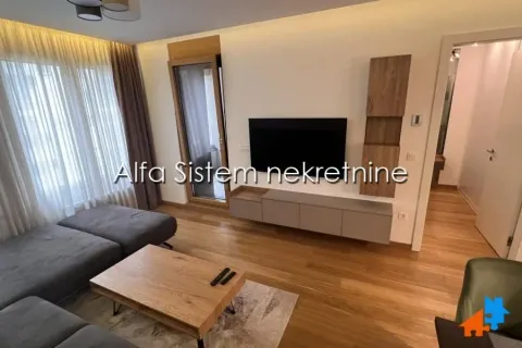 Living room with a sofa, TV, and access to the terrace. - image 2