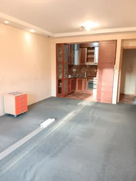 Spacious living room with a view of the built-in kitchen. - image 3