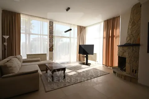 Spacious living room with a fireplace and large glass surfaces. - image 5