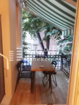 Furnished terrace with a table, chairs, and awning. - image 11