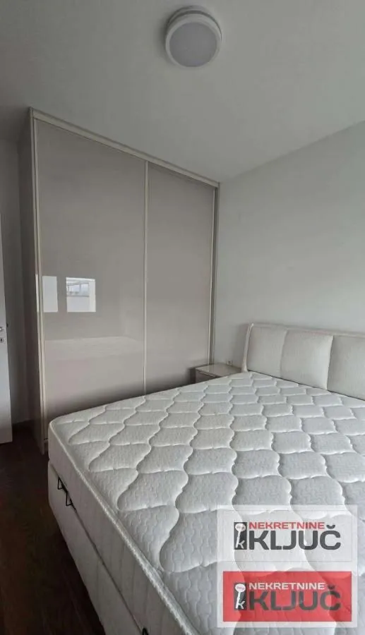 Bedroom with a double bed and a fitted wardrobe.