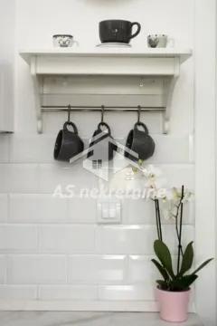 White wall-mounted shelf with mugs and a decorative flower on a tiled wall. - image 13