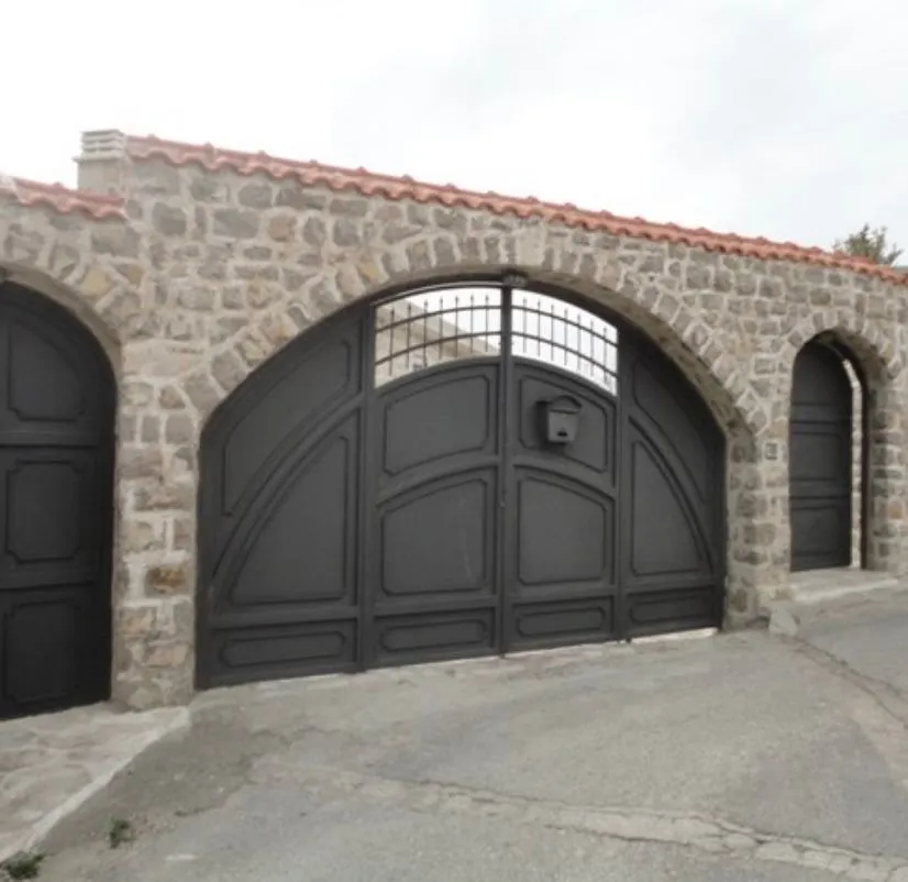 Kamena ograda sa velikom lukarnom kapijom i dvorišnim ulazom.