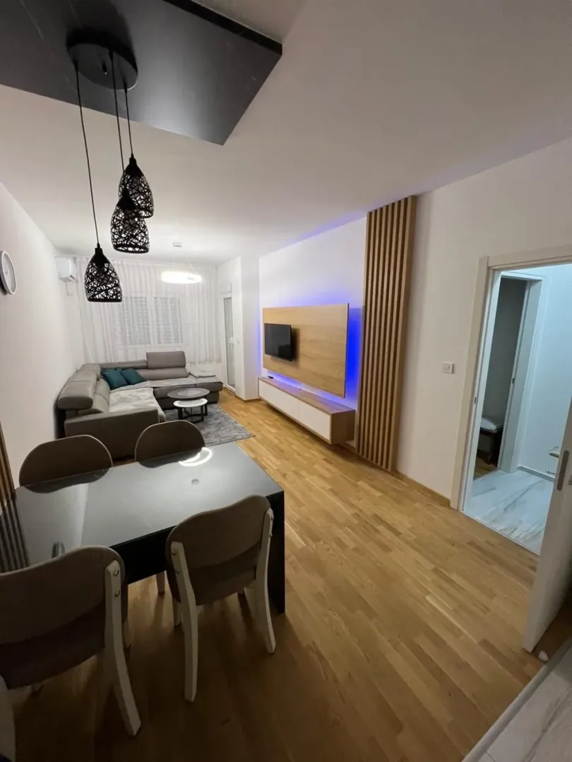 Svijetao dnevni boravak sa trpezarijom i modernim namještajem.