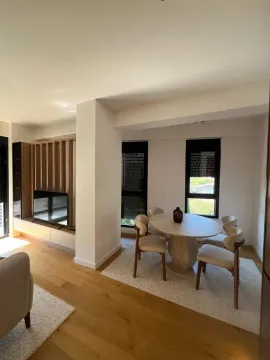 Spacious living room with a dining area and modern wooden details. - image 12