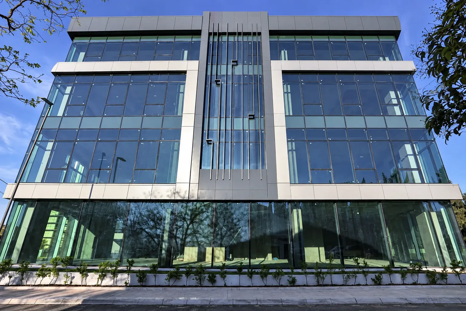 Modern commercial building with a glass facade and metal elements.