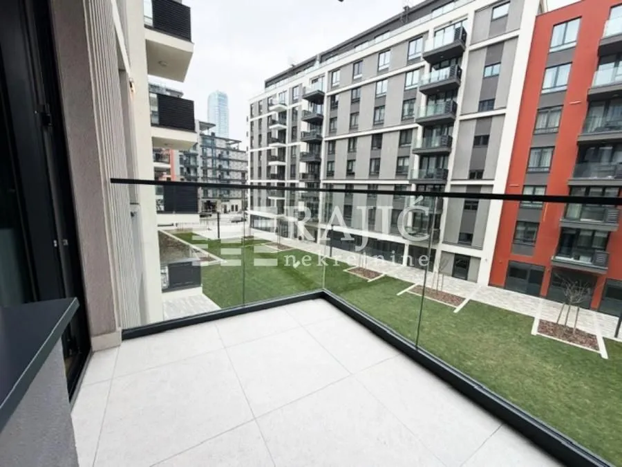 View from the tiled terrace overlooking the courtyard and surrounding buildings.