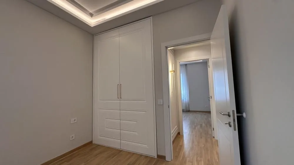 Bedroom with a built-in wardrobe and an open door leading to the hallway.