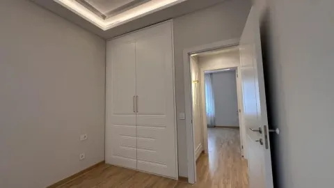 Bedroom with a built-in wardrobe and an open door leading to the hallway. - image 10