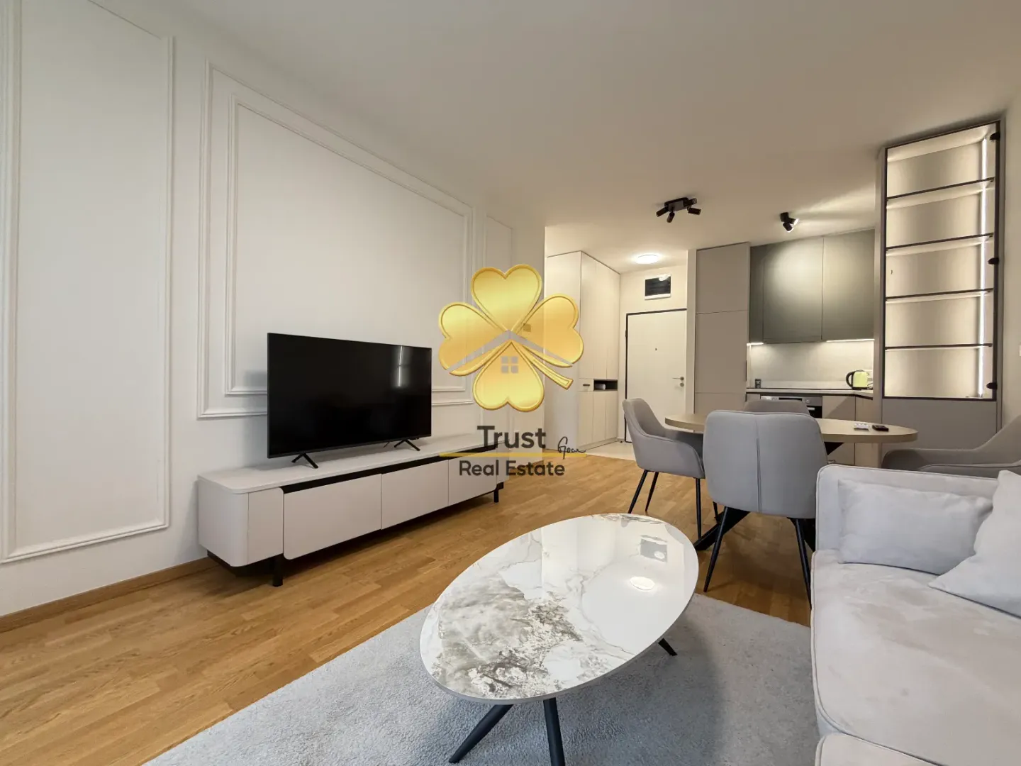 Modern living room connected to the dining area and kitchen.