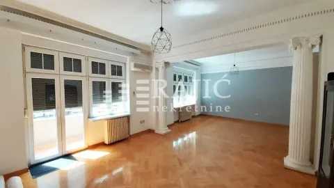 Spacious bright living room with parquet flooring and decorative columns. - image 13