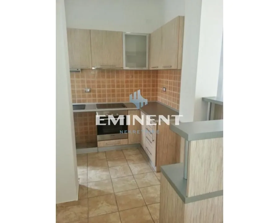 Small kitchen with wooden elements and ceramic tiles.