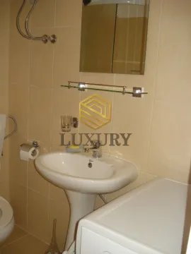 Smaller bathroom with a sink and a mirror, tiled with ceramic tiles. - image 6