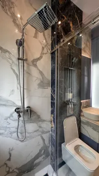 Moderno kupatilo sa tuš kabinom i mermernim pločicama. - image 18
