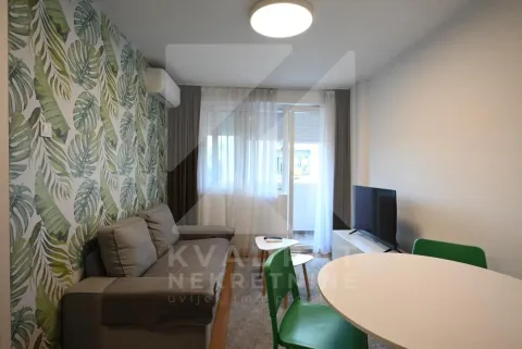 Living room with a sofa, dining table, and access to the terrace. - image 9