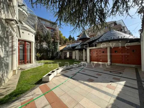 View of the landscaped courtyard with a paved area and lawn in front of the building. - image 20
