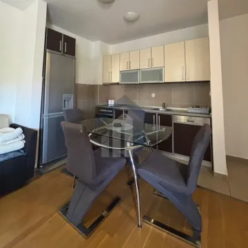 Smaller kitchen with a dining table and chairs as part of the living area. - image 4