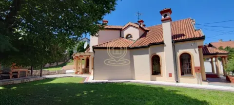 View of the exterior of the house with a landscaped yard and lawn. - image 4
