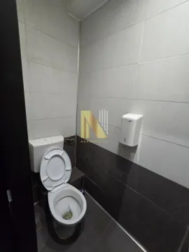 Small bathroom with a toilet and white ceramic tiles. - image 8