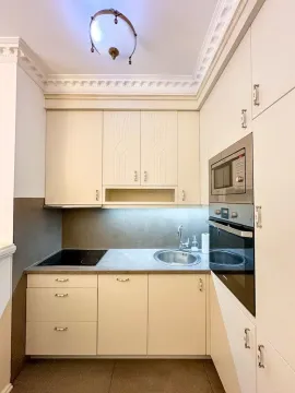 Small bright kitchen with built-in cabinetry and appliances. - image 5