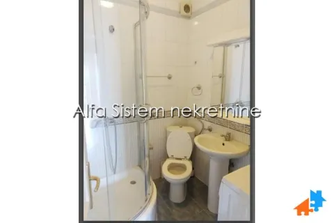 Smaller bathroom with a shower cabin, washbasin, and toilet. - image 10