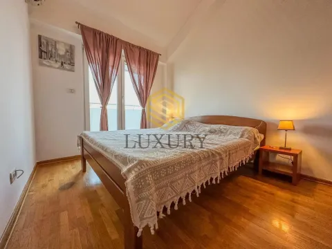 Bedroom with a double bed, wooden flooring, and a window with curtains. - image 7