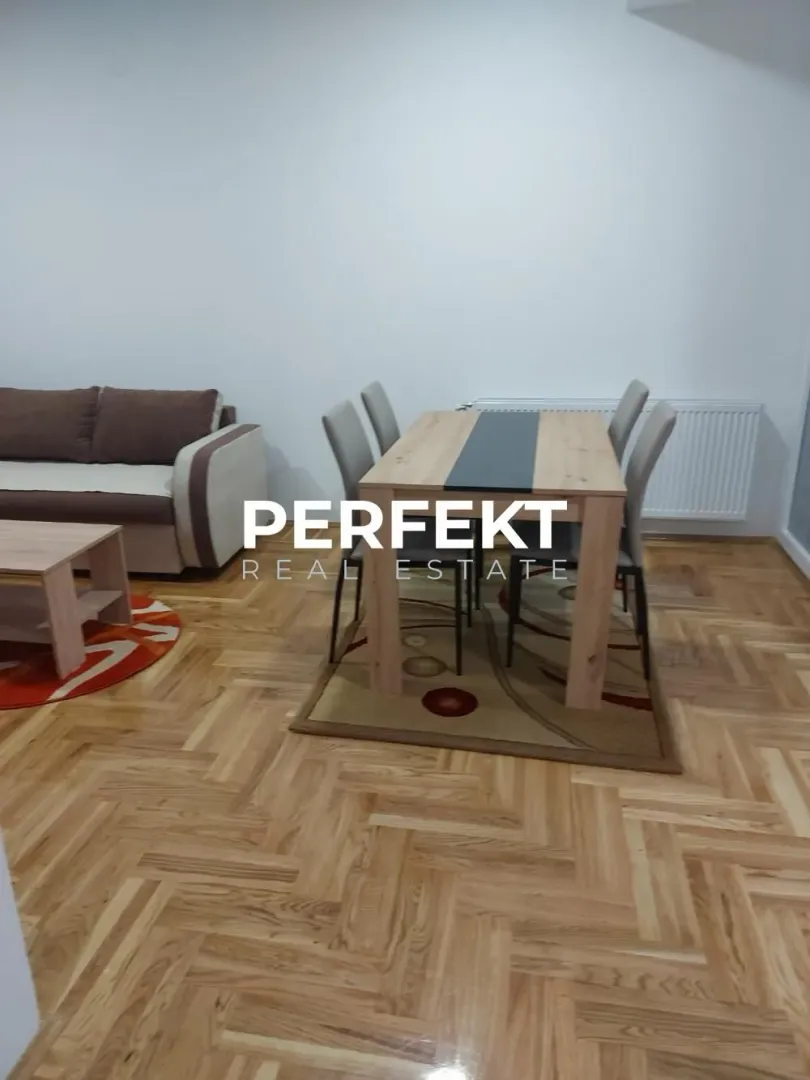Living room with a dining table and sofa.