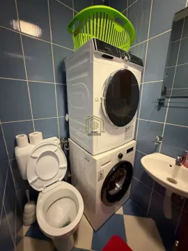 Kupatilo opremljeno toaletom, umivaonikom i mašinama za veš. - image 9