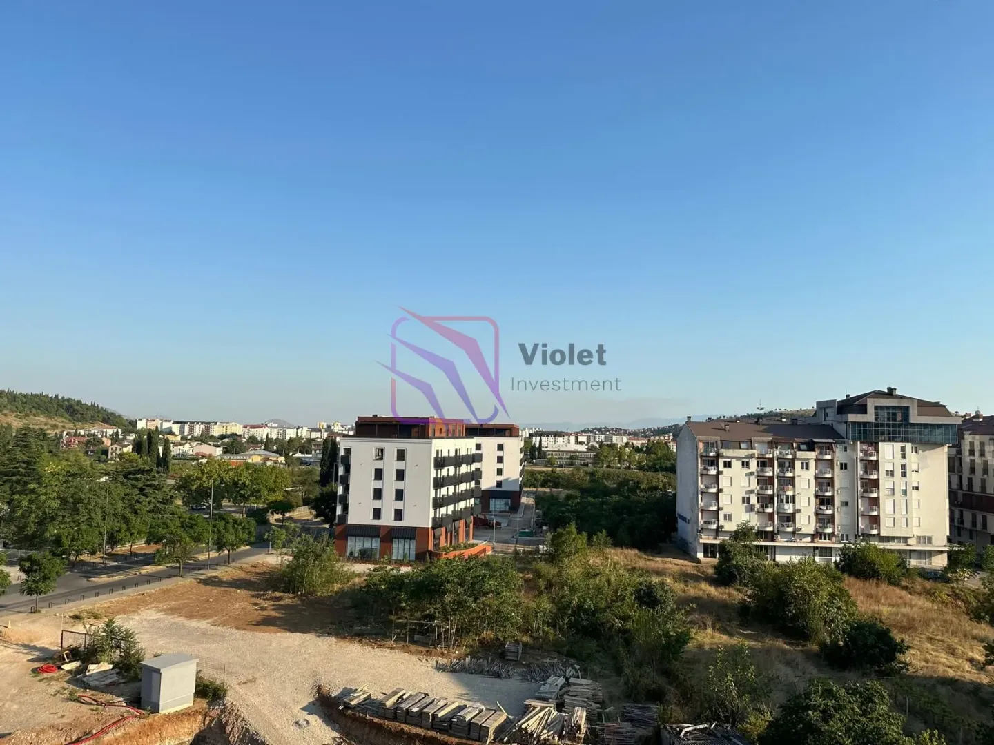 View from the window overlooking surrounding residential buildings and the urban neighborhood.