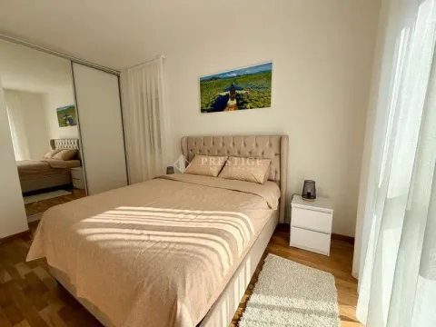Furnished bedroom with a double bed, wardrobe, and nightstand. - image 9