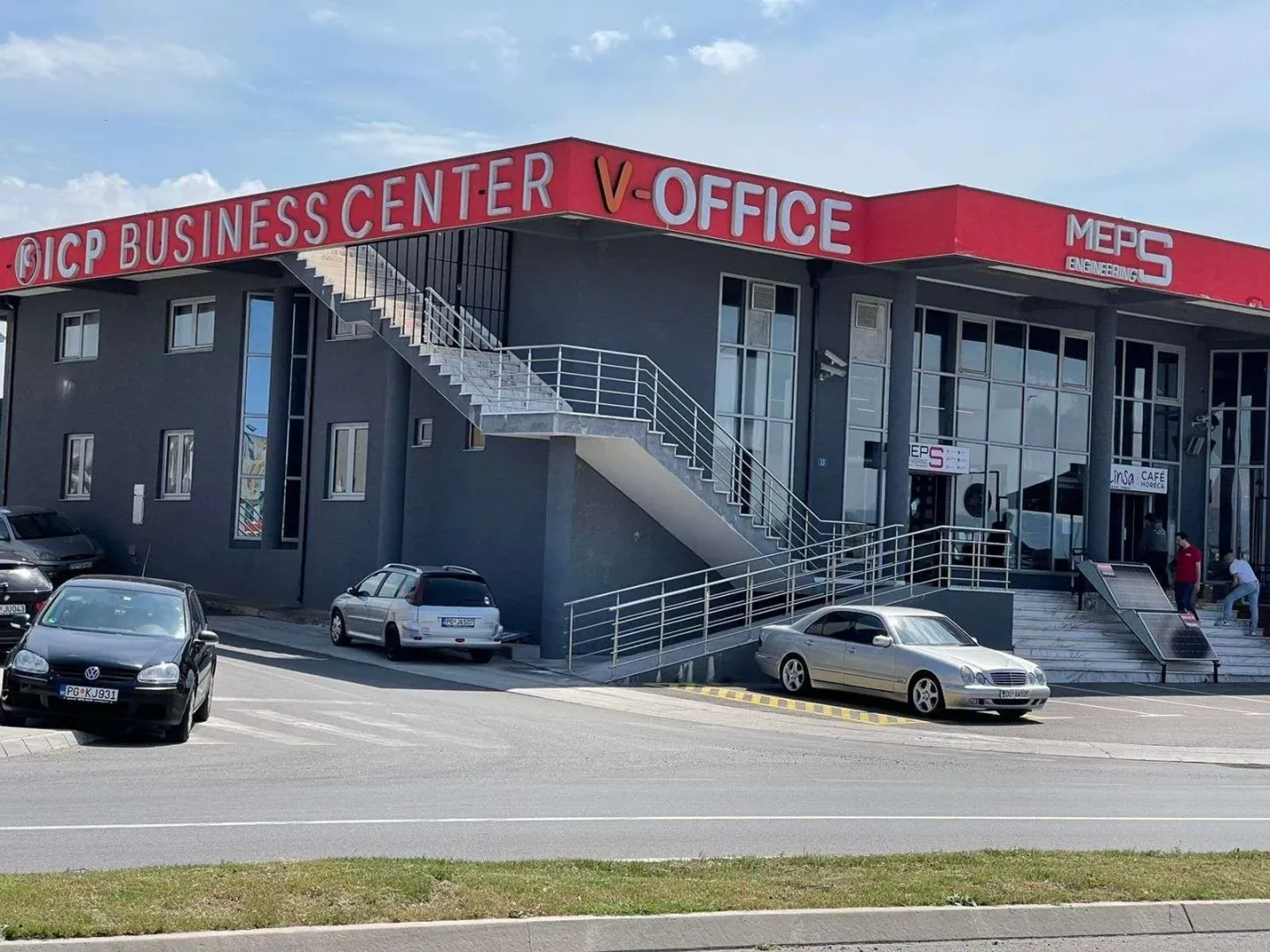 Exterior of a commercial building with parking in front.