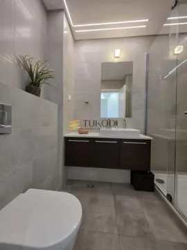 Modern bathroom with a walk-in shower, washbasin, and wall-mounted toilet. - image 25