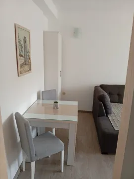 Svijetla prostorija sa trpezarijskim stolom, stolica i dijelom ugaone garniture. - image 3