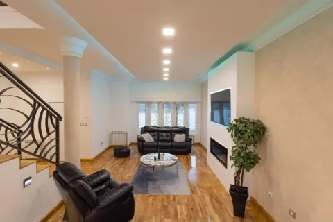 Spacious living room with sofa set, fireplace, TV, and stairs. - image 4
