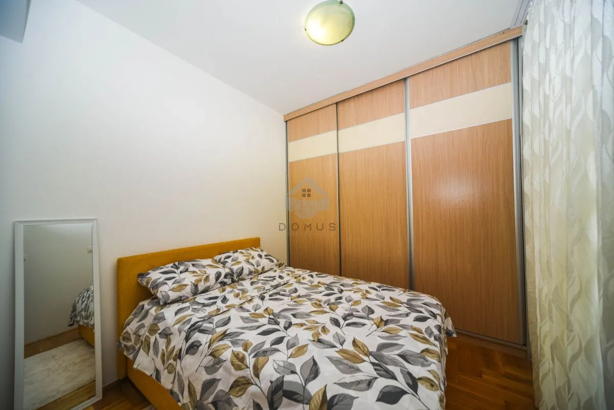 Furnished bedroom with a double bed and built-in wardrobe.