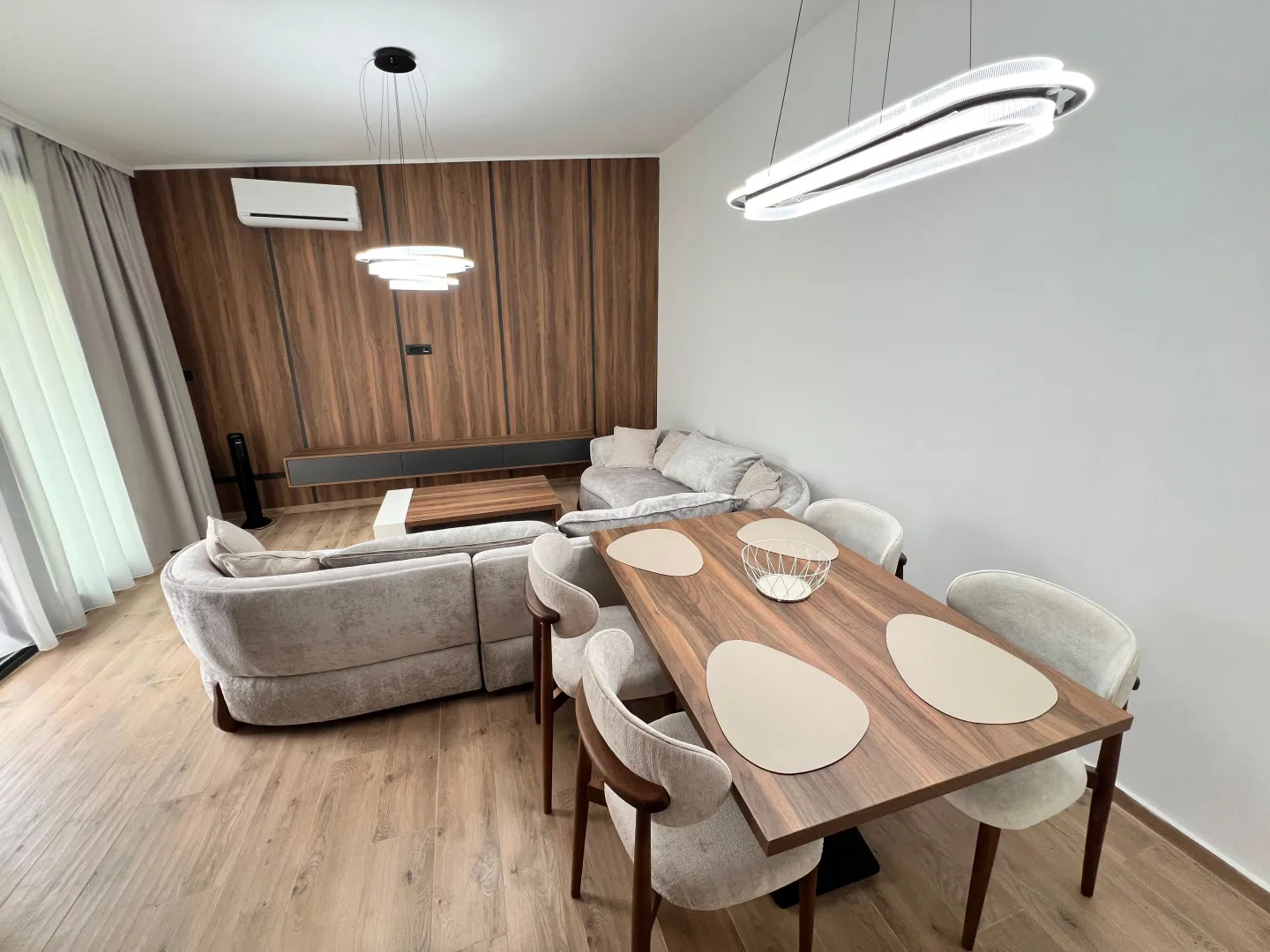 Modern living room with a sofa and dining table.