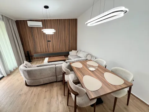 Modern living room with a sofa and dining table. - image 3