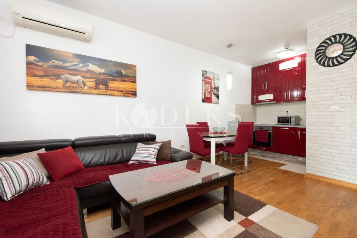Living room with a sofa set and dining area beyond.