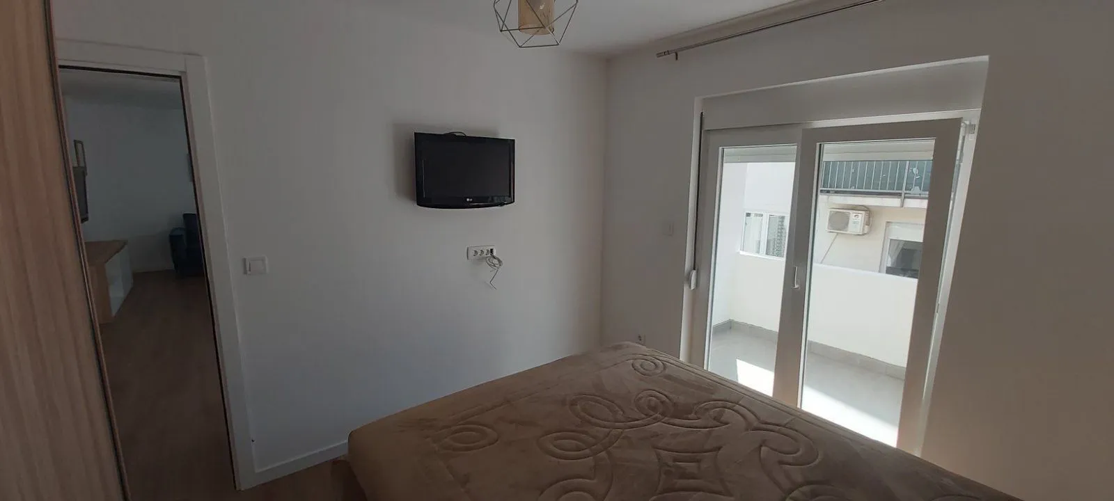 Bedroom with balcony access.