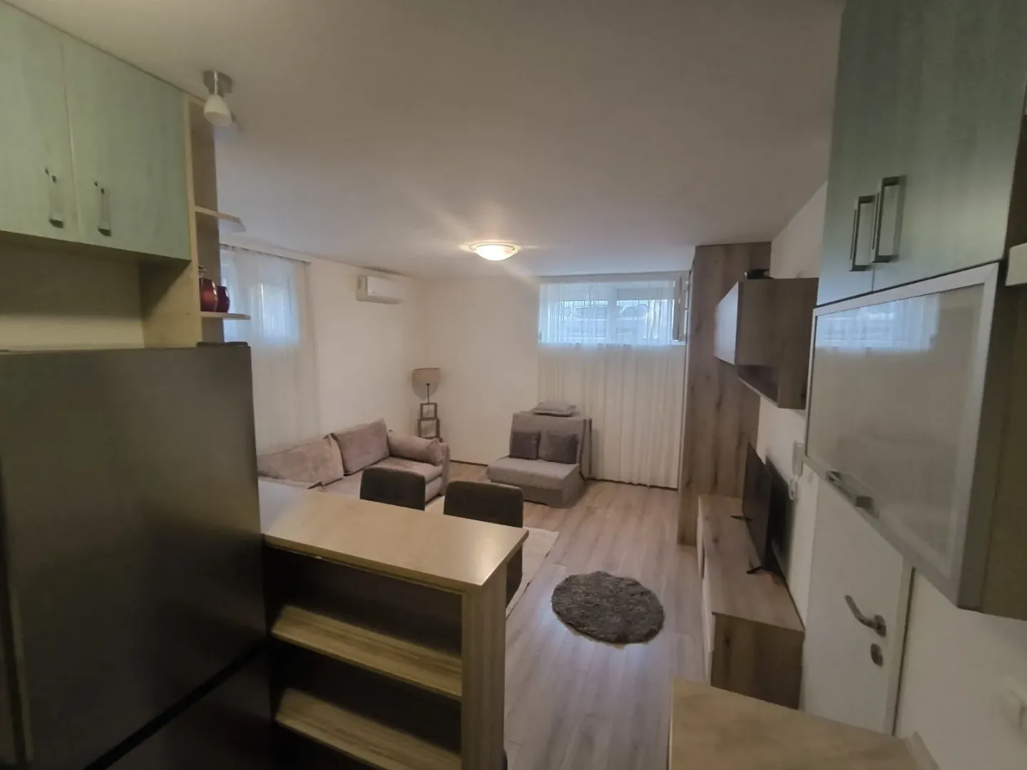 An open-plan living room with a seating area and a bar counter.