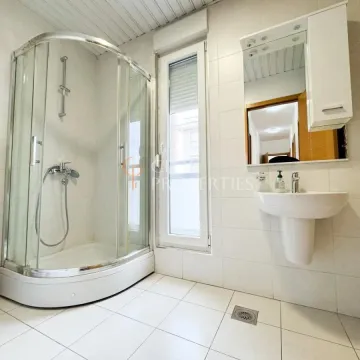 Bathroom with a shower cabin, washbasin, and mirror. - image 2