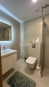 Modernly equipped bathroom with a washbasin, toilet, and walk-in shower. - image 8